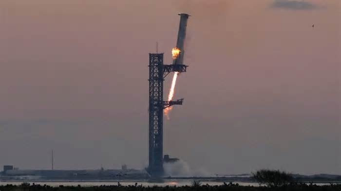 SpaceX catches Starship rocket booster on Texas launch pad