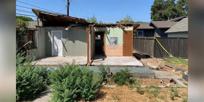 Half a house for half a million dollars: Home crushed by tree hits real estate market