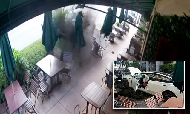 Shocking moment Tesla crashes into Miami restaurant before its 'TOURIST' occupants flee the scene