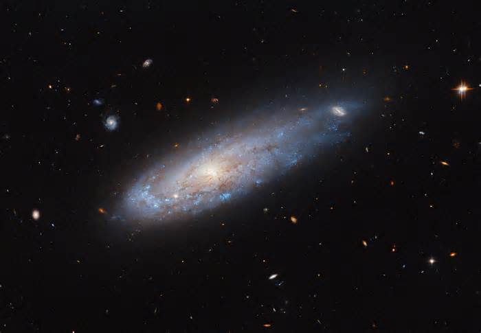 Hubble Spots a Galaxy Zooming Through Space Like a Cosmic Cannonball