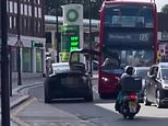 Tesla Model X drives off with one of its 'falcon wing' doors open and smashes into a London bus 