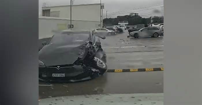 Out-of-control Tesla crashes into cars, plunges off carpark roof